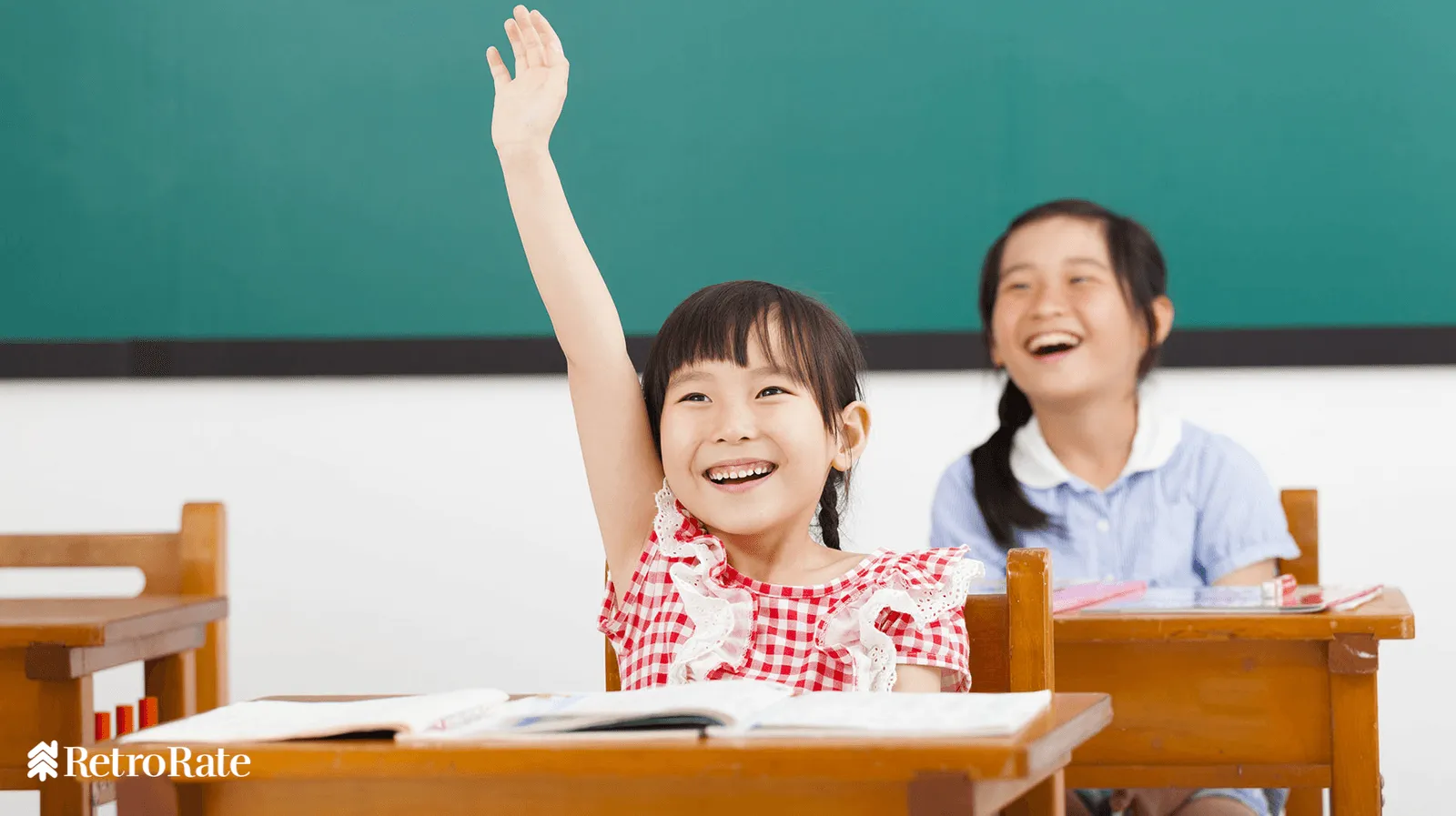 Girl raising her hand in class.